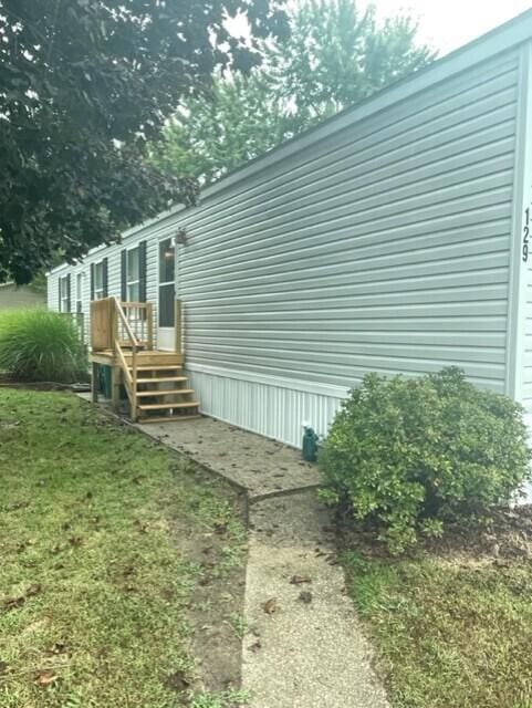 view of property exterior featuring a lawn