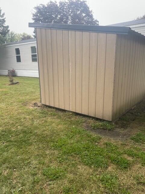 view of outbuilding with a yard