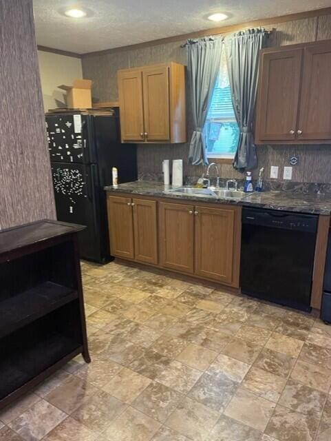 kitchen featuring a textured ceiling, sink, tasteful backsplash, and black appliances