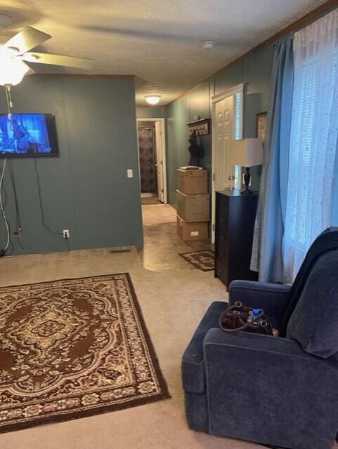 living room featuring ceiling fan and light carpet