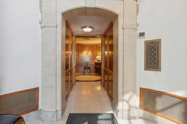 hall with light tile patterned floors