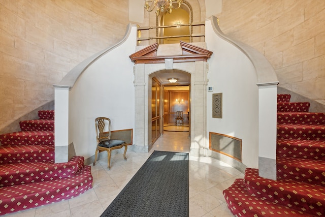 interior space featuring light tile patterned flooring and a high ceiling