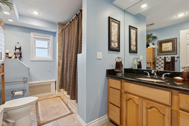 bathroom featuring tile patterned flooring, vanity, toilet, and a textured ceiling