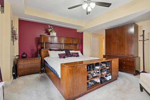 carpeted bedroom featuring ceiling fan, a closet, and a textured ceiling