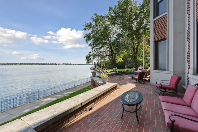 view of patio featuring an outdoor living space and a water view