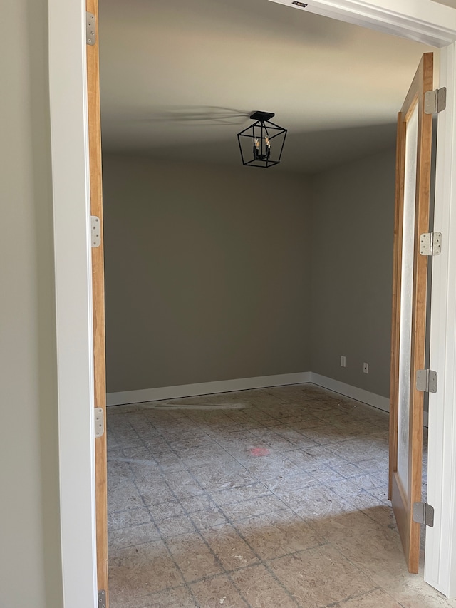 unfurnished room featuring baseboards