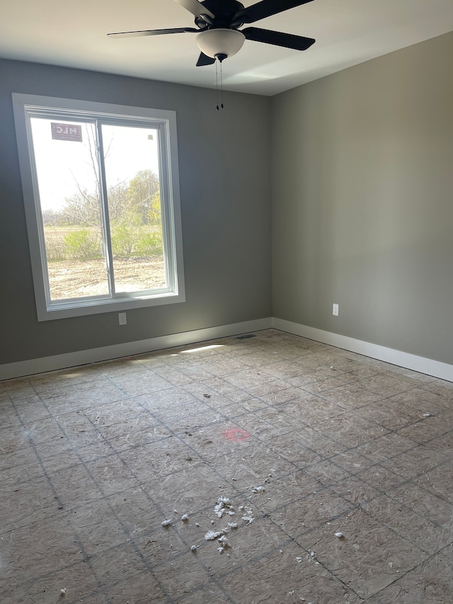 empty room with baseboards and a ceiling fan