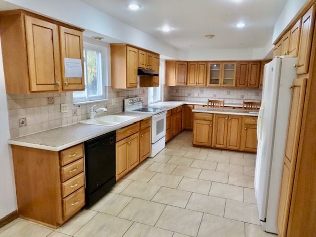 kitchen featuring decorative backsplash, light tile patterned floors, white appliances, and sink