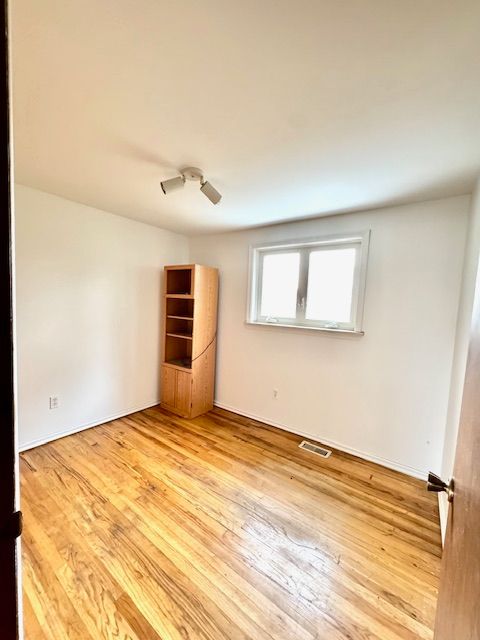 unfurnished room with hardwood / wood-style floors