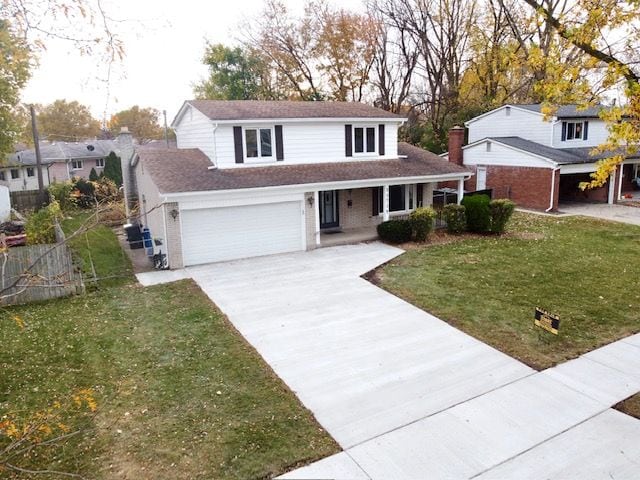 front of property featuring a garage, covered porch, and a front yard