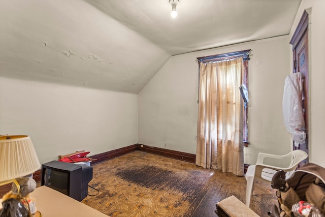 additional living space featuring dark hardwood / wood-style flooring and vaulted ceiling