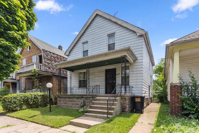 bungalow-style house with a front lawn and a porch