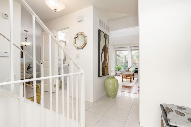2100 Hyde Park Rd, Detroit, MI 48207 - hallway with light tile patterned floors, stairway, and baseboards