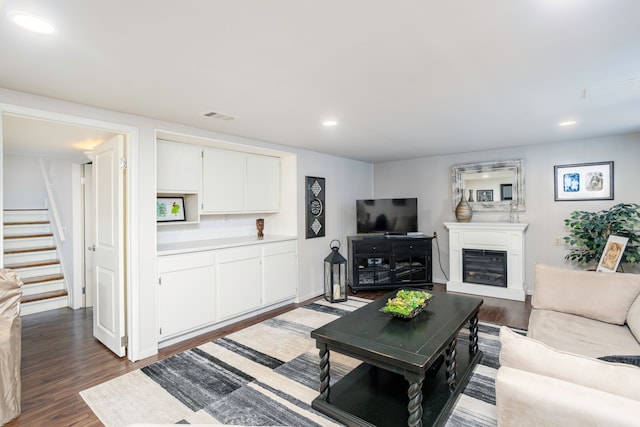 2100 Hyde Park Rd, Detroit, MI 48207 - living area featuring dark wood-style floors, stairs, a glass covered fireplace, and recessed lighting