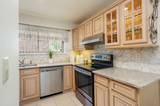 2100 Hyde Park Rd, Detroit, MI 48207 - kitchen featuring stainless steel appliances, a sink, under cabinet range hood, backsplash, and glass insert cabinets
