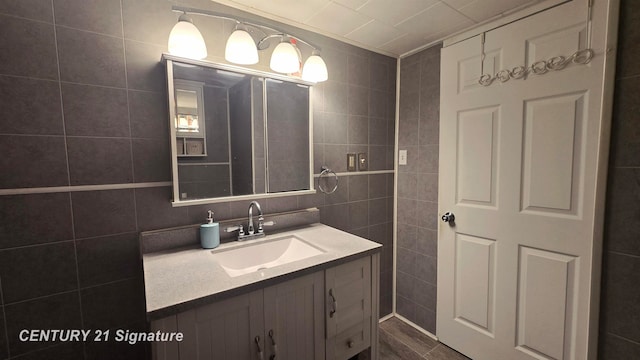 bathroom featuring vanity, wood-type flooring, and tile walls