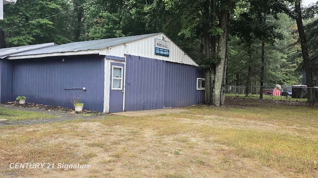 view of outbuilding featuring a yard