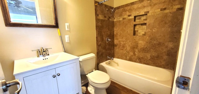 full bathroom featuring wood-type flooring, vanity, toilet, and tiled shower / bath combo