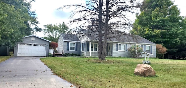 view of front facade with an outbuilding, a garage, and a front yard