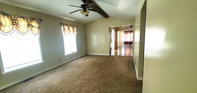 carpeted spare room featuring plenty of natural light, lofted ceiling with beams, and ceiling fan