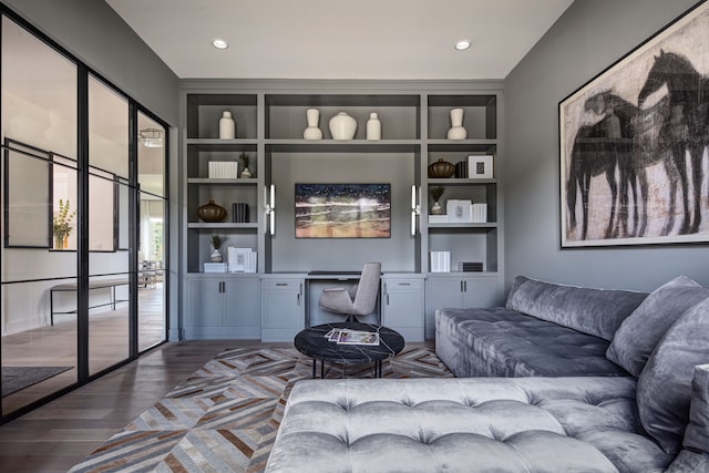 living room featuring hardwood / wood-style floors and built in features