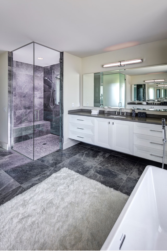 bathroom with vanity and independent shower and bath