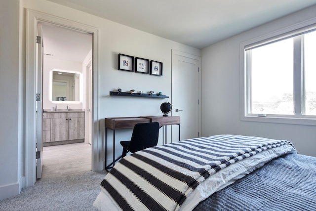 carpeted bedroom featuring ensuite bath