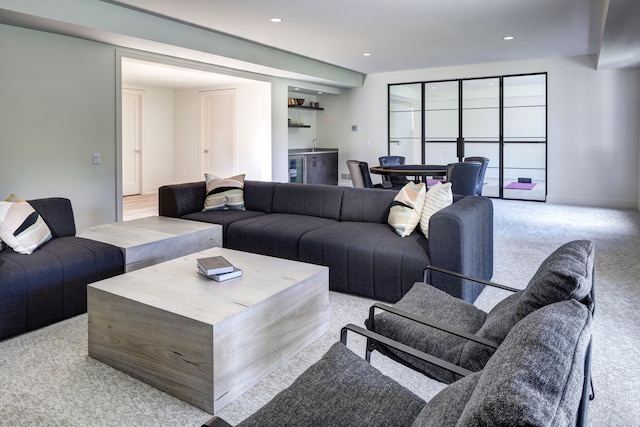 living room with bar area and light carpet