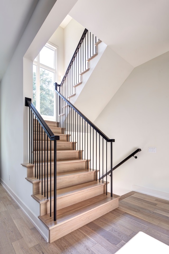 stairs with wood-type flooring