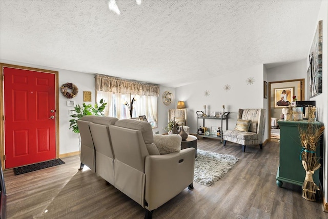 living room with a textured ceiling and dark hardwood / wood-style floors