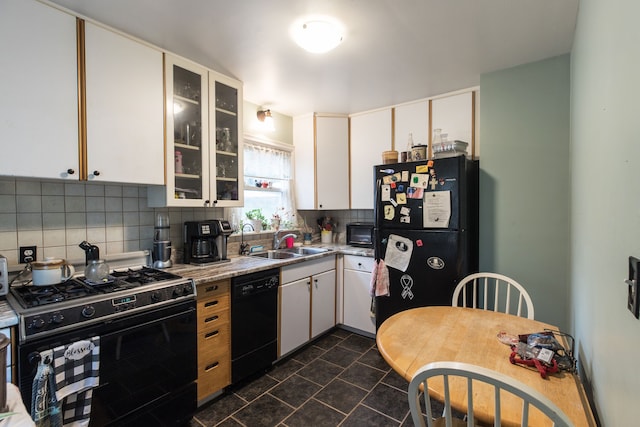 kitchen with white cabinets, decorative backsplash, sink, and black appliances