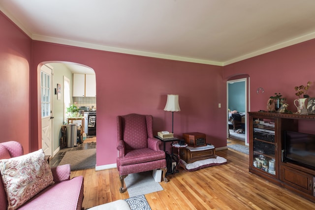 living room featuring wood-type flooring and crown molding