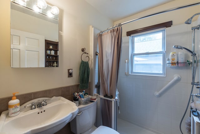 bathroom featuring curtained shower, sink, and toilet