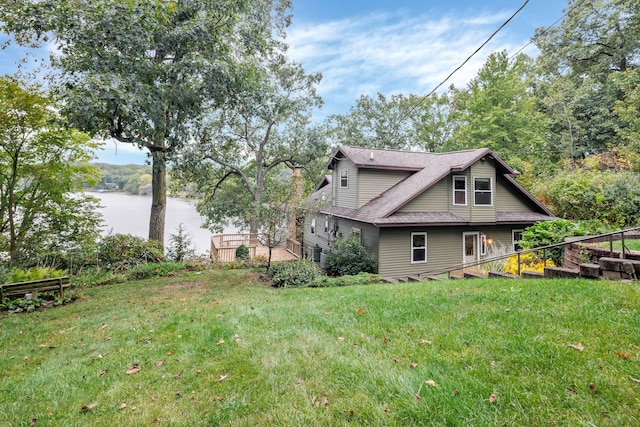 view of side of property featuring a water view and a yard