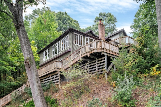 rear view of house featuring a deck