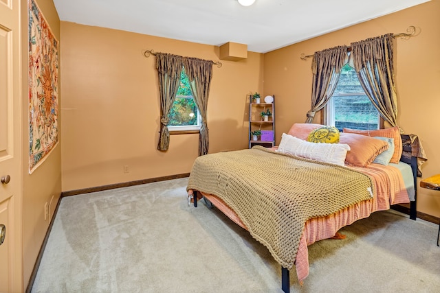 carpeted bedroom with multiple windows