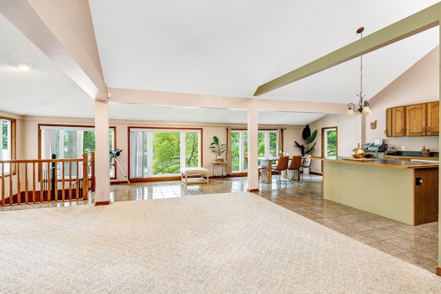 kitchen featuring a chandelier, pendant lighting, and vaulted ceiling