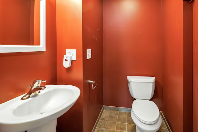 bathroom with tile patterned flooring, toilet, and sink