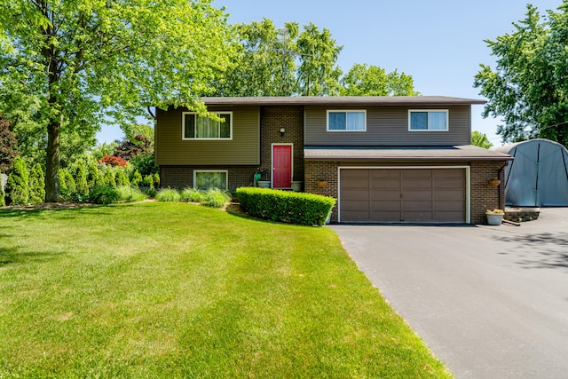 raised ranch with a garage and a front lawn