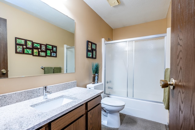 full bathroom with toilet, combined bath / shower with glass door, a textured ceiling, and vanity