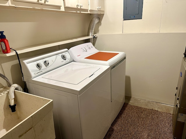 clothes washing area with cabinets, electric panel, separate washer and dryer, and sink