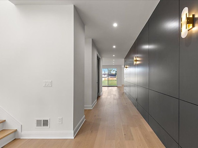 corridor with light hardwood / wood-style floors