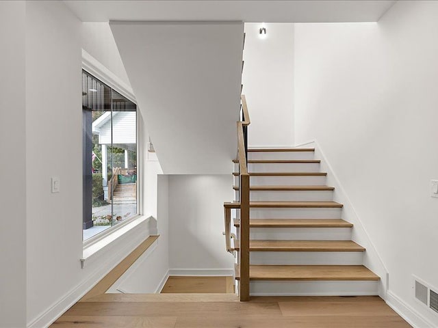 stairway with hardwood / wood-style flooring