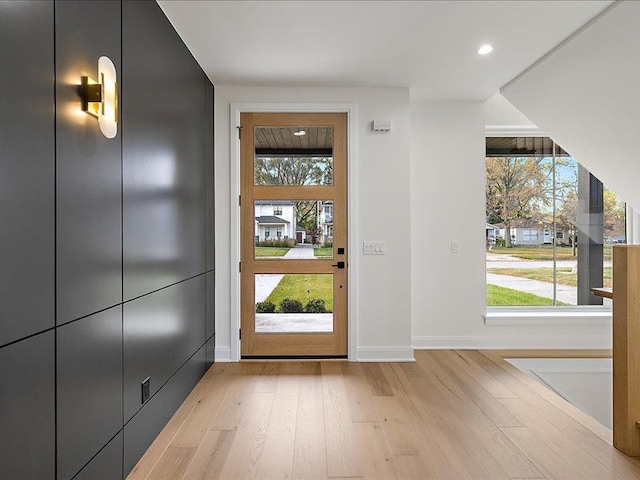 entryway with light wood-type flooring and a healthy amount of sunlight