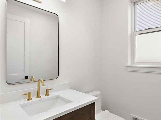 bathroom featuring vanity and toilet