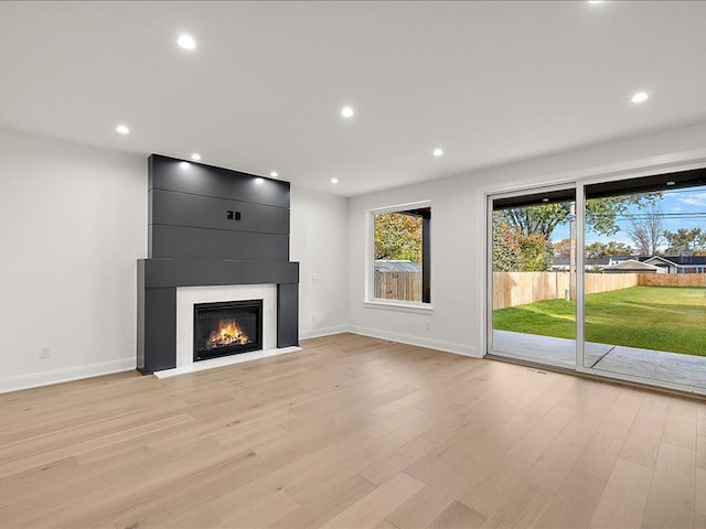 unfurnished living room with light hardwood / wood-style floors and a fireplace