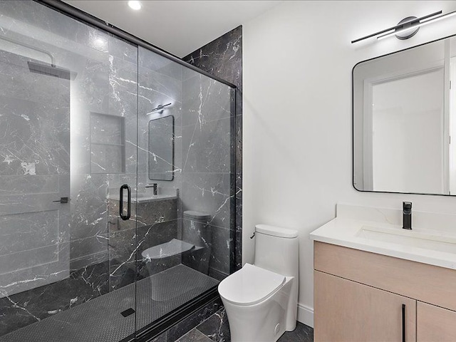 bathroom with vanity, toilet, and an enclosed shower