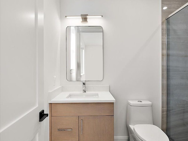 bathroom with a shower with door, vanity, and toilet