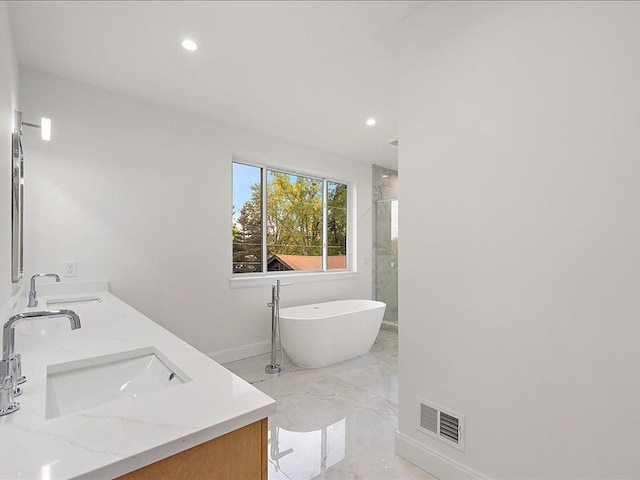 bathroom with vanity and independent shower and bath