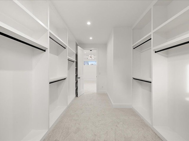 walk in closet with light colored carpet